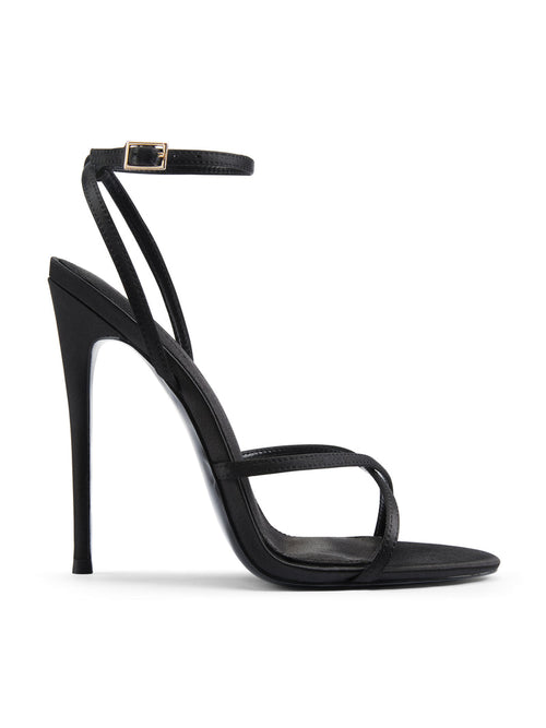 Femme LA Ale Sandal in Satin Black – side profile showing crossed thin toe straps, ankle strap with gold buckle, and slim stiletto heel