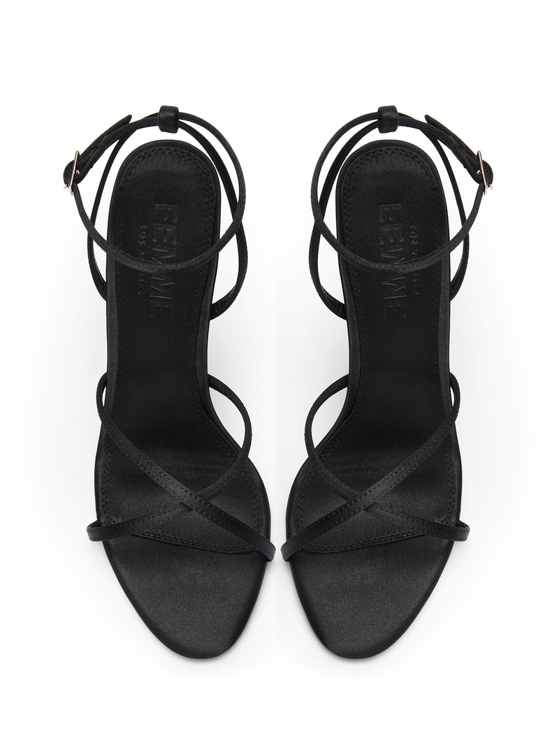 Femme LA Ale Sandal in Satin Black – top-down view of the pair showing crossed toe straps, ankle buckle detail, and Femme LA branded insoles