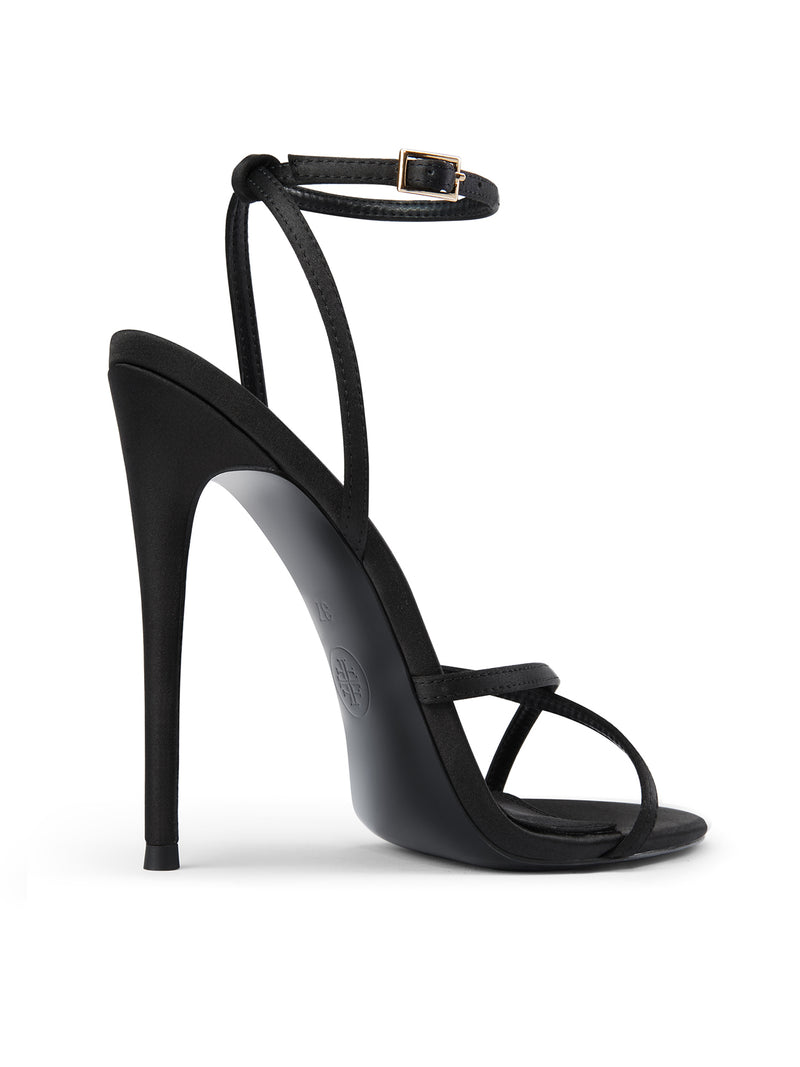 Femme LA Ale Sandal in Satin Black – back three-quarter view showing ankle buckle strap, Femme LA embossed heel, and slim stiletto