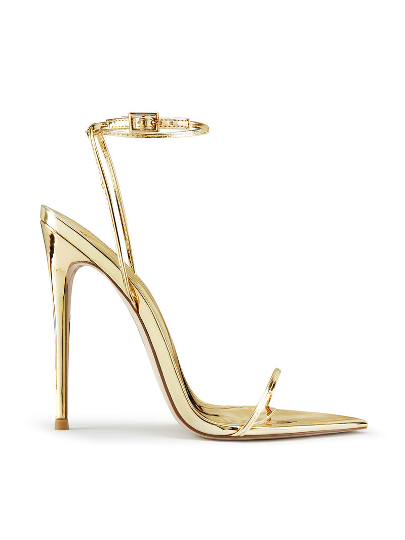 Liquid gold mirror ANDX Sandal by FEMME LA, side view showing barely-there design with single toe strap, ankle strap with buckle, and ultra-slim stiletto