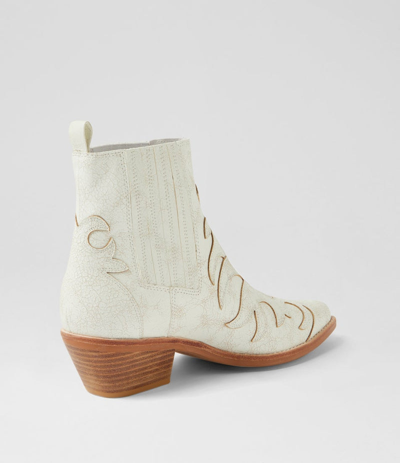 White cowboy boot with brown sole on a light gray background