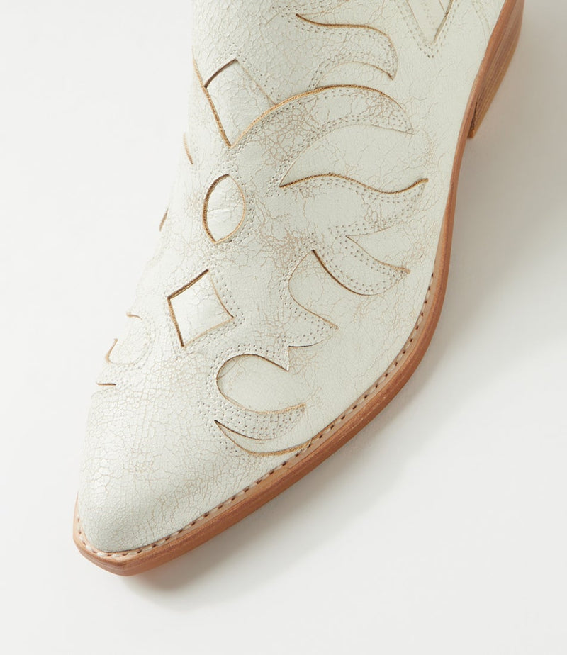 White cowboy boot with brown sole on a light gray background