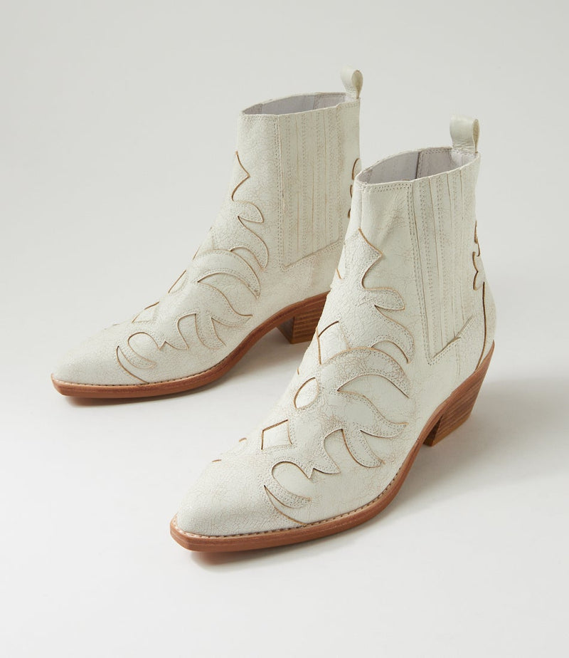 White cowboy boot with brown sole on a light gray background