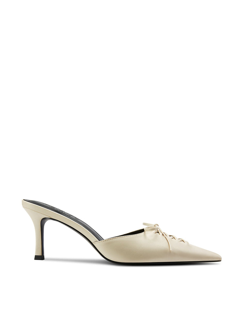 Femme LA Louis Slipper in Cream – side profile of cream leather mule with lace-up corset detail and bow at pointed toe, slim stiletto heel