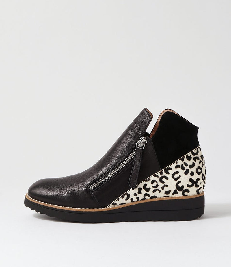 Black wedge shoe with leopard print heel on a light gray background