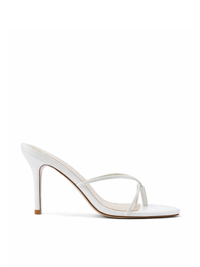 Femme LA Sicilian Slipper in White – side profile showing white leather body and slim crossed straps on a white stiletto heel
